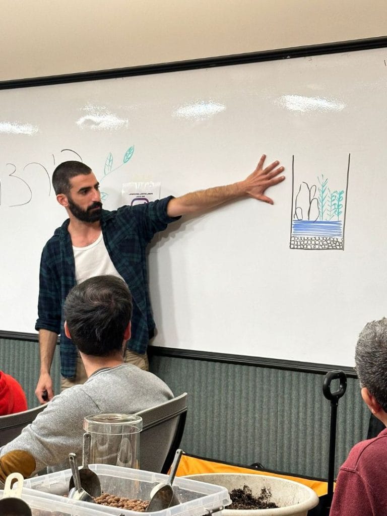 man showing drawing on the wall